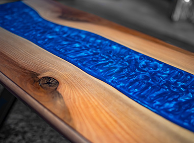 wood table with blue resin river design showcasing natural grain and texture beautiful 3D effect