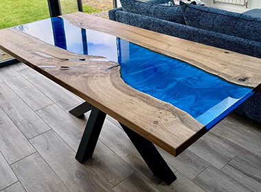 modern wooden table with blue resin river design and natural wood texture showcasing a stylish interior decor element